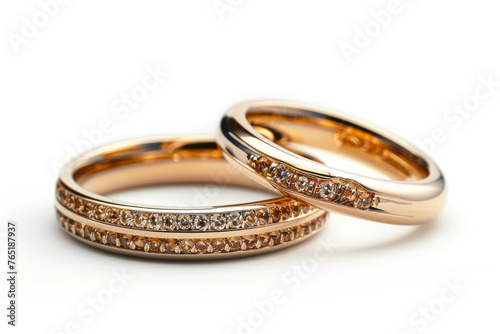 Exquisite Golden Wedding Bands Adorned with Stones on a Pure White Background