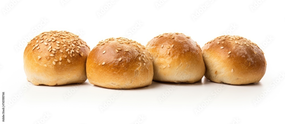 Four bread buns with sesame seeds on white backdrop