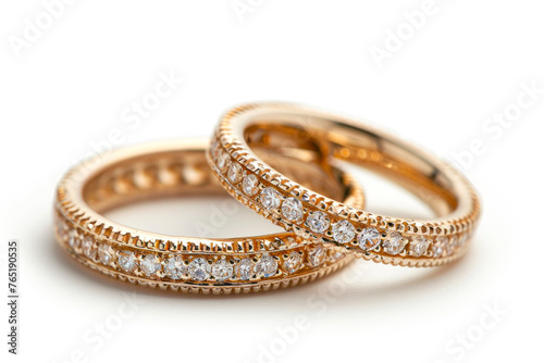 Exquisite Gold Wedding Bands Adorned with Stones on a White Background, Radiating Elegance