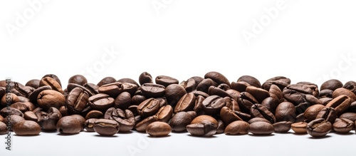 Many scattered coffee beans on a white background