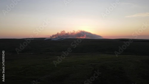 A drone view of the sunset coming through the smoke of a gorse fire at Bragan Mountains, Monaghan, Ireland
 photo