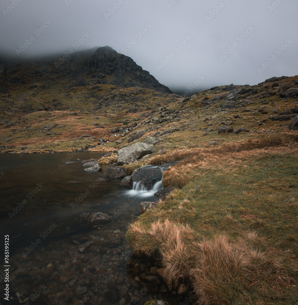 Mountain stream feeds a lake at the Old Man of Coniston