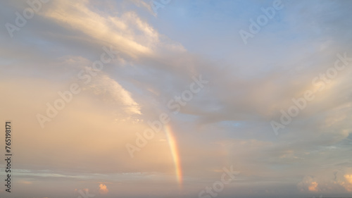 Vibrant enchanting beauty of a rainbow arcing across the sky after a rain shower, symbolizing hope, wonder, and the magic of natural phenomena. © Dennis