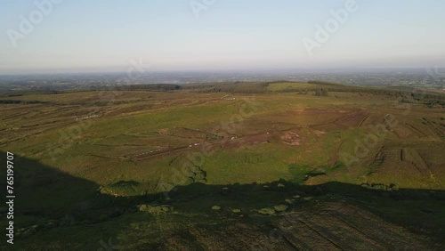 A drone shot along the top of the green mountains just before sunset on a summers day at Bragan Mountains, Co. Monaghan, Ireland photo