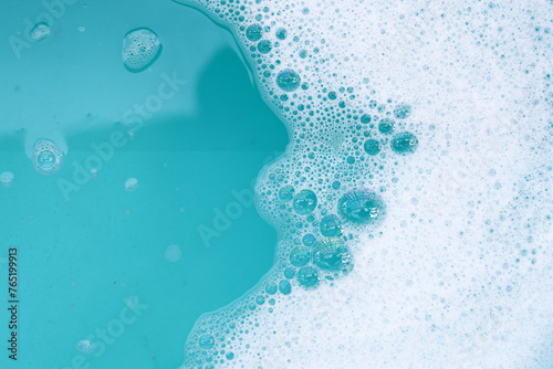 Detergent foam bubble on water. Blue background, Soap sud © Bowonpat