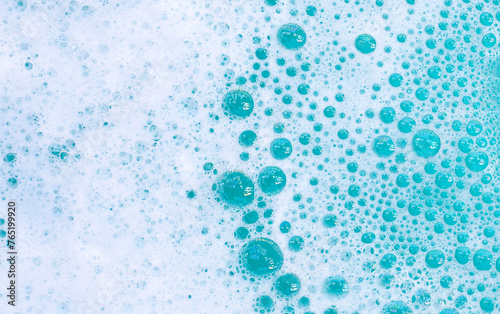 Detergent foam bubble on water. Blue background  Soap sud