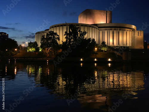 View of the Opera Nova opera house reflected in Brda river during blue hour, Bydgoszcz, Poland, May 2019