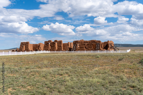 Fort Union National Monument in New Mexico. Preserves fort's adobe ruins along Santa Fe Trail. Hospital remnants with white fence. Post surgeons cared for the health of soldiers and civilians. 