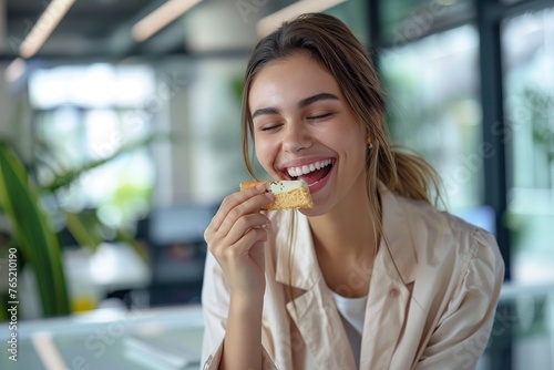 Woman Eating Protein Bar at Table