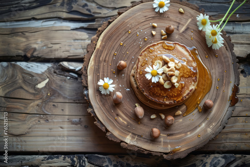 homestyle buckwheat pancakes with honey topping and nuts on natural wood slice plate photo