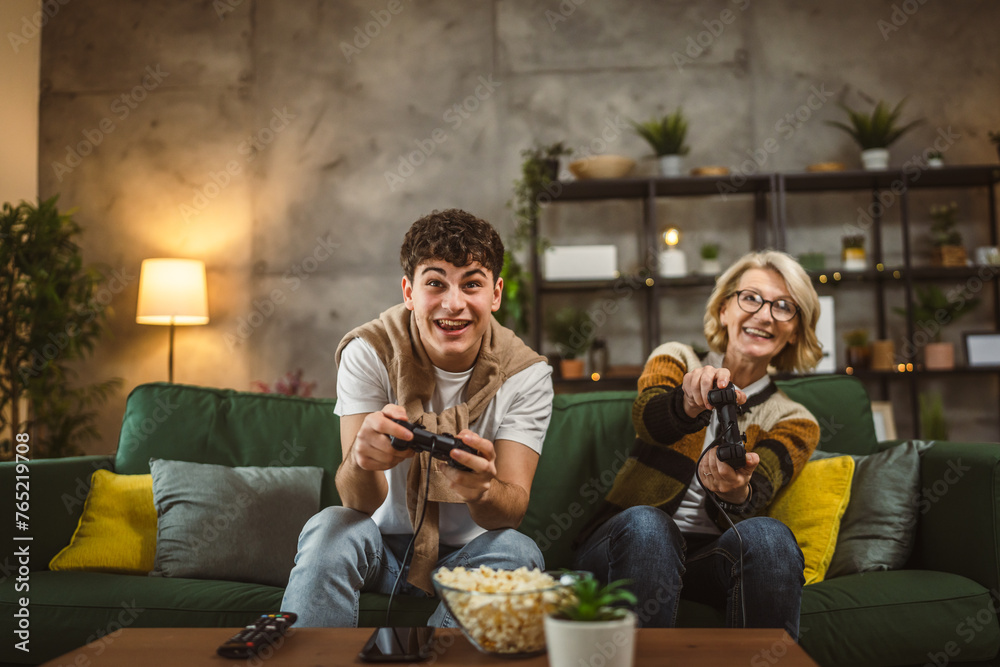 teenager male and his mother mature woman man play console video game teenager male and his mother mature woman man play console video game