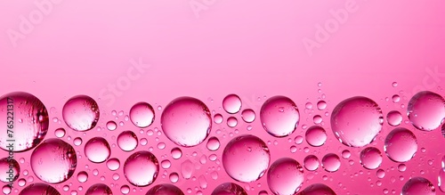 A close-up view of a pink surface with numerous small water droplets scattered across it