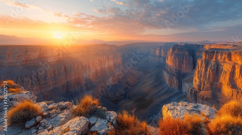 The sun sets over the canyon, painting the sky with vibrant colors