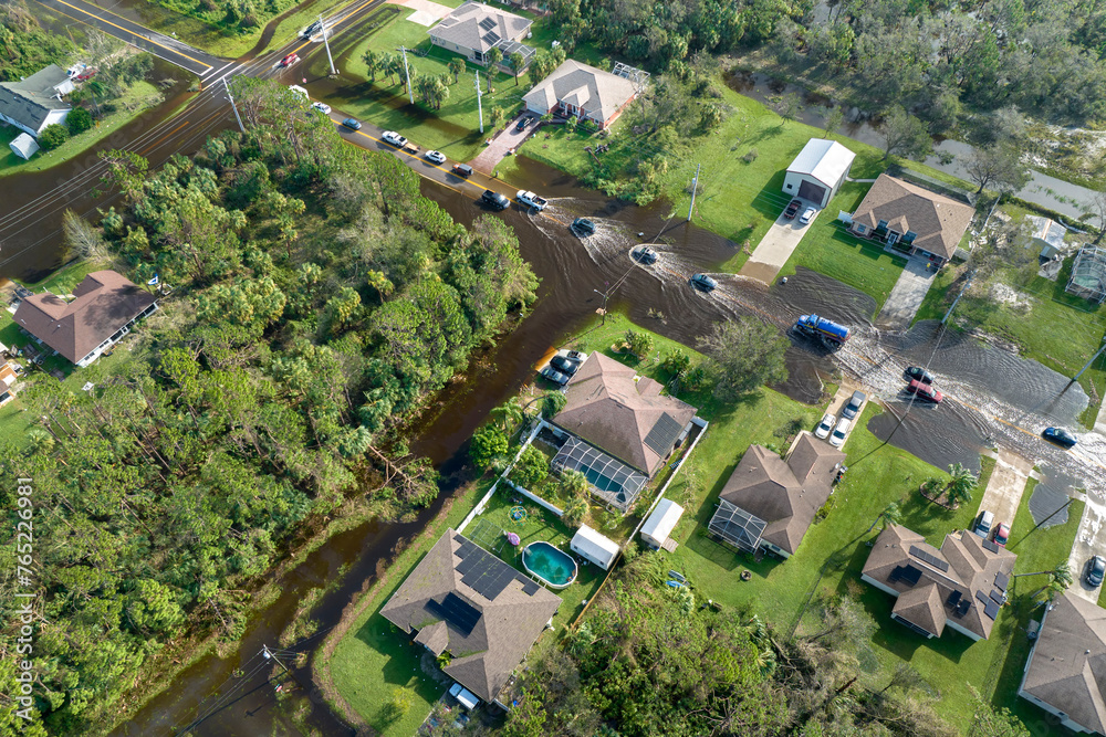 Surrounded by hurricane rainfall flood waters homes in Florida residential area. Aftermath of natural disaster Surrounded by hurricane rainfall flood waters homes in Florida residential area. Aftermath of natural disaster