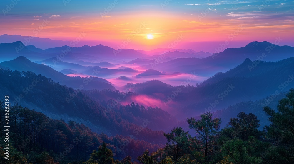 Sun setting behind fogcovered mountains, painting the sky with colors of dusk