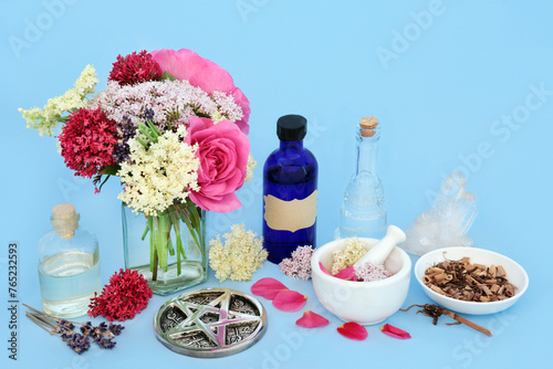 Tranquilizing flowers herbs with valerian root, rose, elder and lavender used in alternative herbal medicine. Adaptogen food ingredients with tincture, oil, water bottles with crystal.