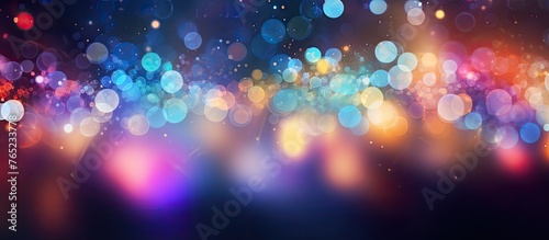 A hazy photo of various vibrant lights against a dark backdrop, creating a blend of tints and shades including waterinspired blues, purples, and magentas
