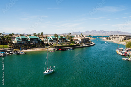 A sail boat sails under the old London Bridge, which was relocated from London England in the 1970’s to Lake Havasu Arizona.