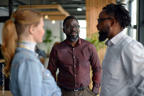 Boss introducing black new worker to workmates