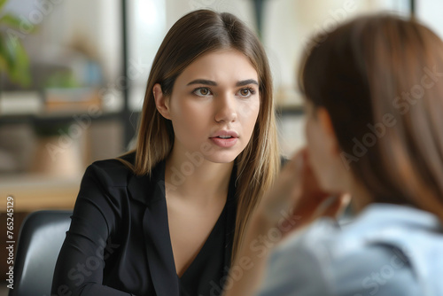 Serious professional female advisor consulting client at meeting talking having business conversation or making offer insurer giving advice mentor teaching intern hr speaking at job interview
