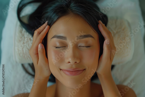 Malay woman enjoying massage at spa salon hotel, therapist treatment