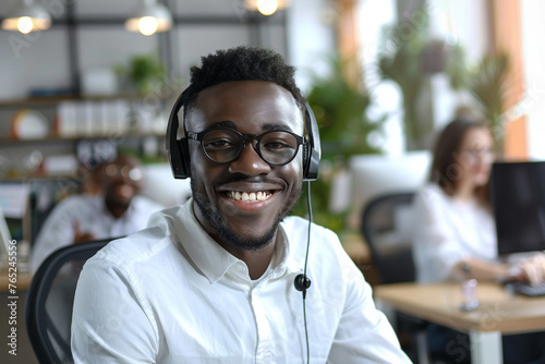 Smiling young african businessman call center agent laugh at workplace