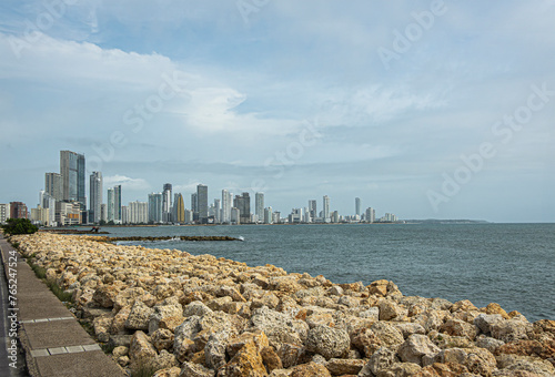 Cartagena, Colombia - July 25, 2023: Seen from where Calle 33 meets Avenida Santander, Panorama, Tall buildings skyline on NW side of Bocagrande peninsula. Rocky shore upfront photo