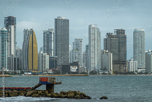 Cartagena, Colombia - July 25, 2023: Seen from where Calle 31 meets Avenida Santander, breakwater and Tall buildings skyline on north sea side of Bocagrande peninsula. photo