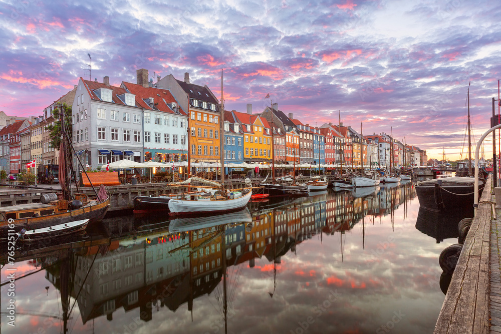 Nyhavn with colorful facades of old houses and ships in Old Town of Copenhagen, capital of Denmark.