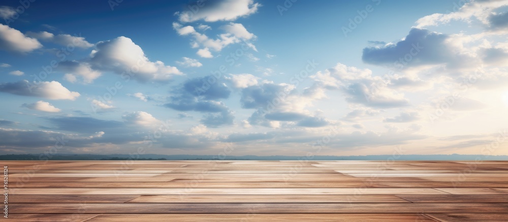 A wooden table is set against a backdrop of a cloudy sky, creating a natural landscape with cumulus clouds. The calm atmosphere contrasts with the dynamic meteorological phenomenon in the sky