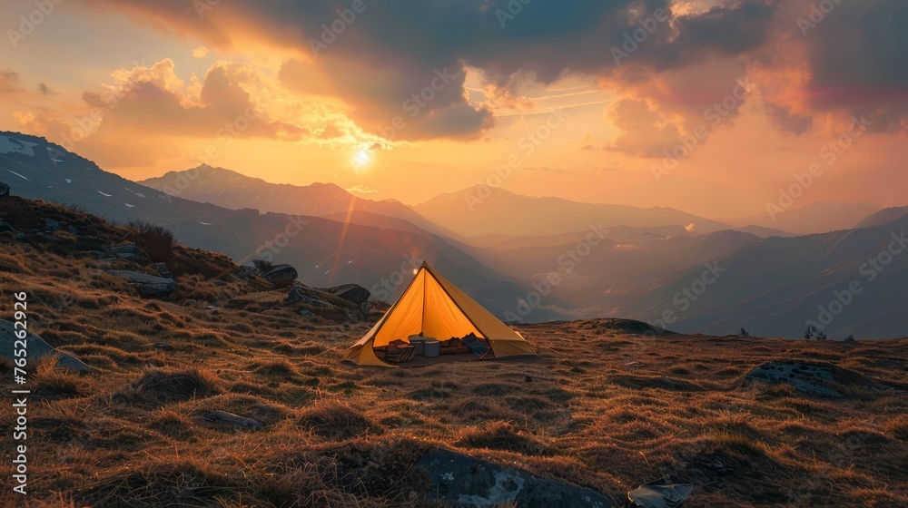 Mountain camping adventure, serene sunset backdrop, wilderness escape, tent overlooking majestic view