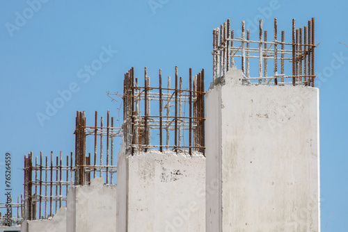 Poured concrete pillars in a high rise construction project showing rebar reinforcing steel
