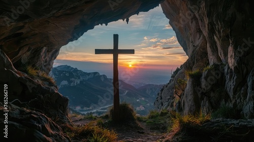 Sunset view of a wooden cross from a cave.