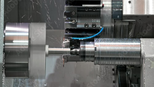 The CNC lathe machine forming cutting the metal shaft parts. hi-technology metal working by CNC turning machine . High quality 4k footage