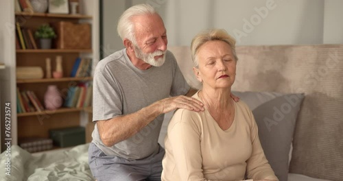 Senior mam massaging his wife in bed