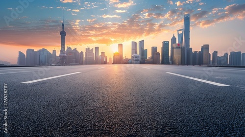 A panoramic skyline showcases modern commercial buildings alongside an empty road, with the asphalt gleaming under the soft glow of the sunrise. 