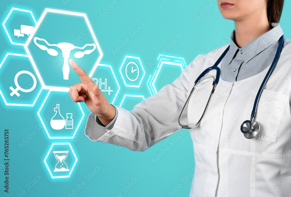 Menopause concept. Doctor touching uterus icon on digital screen against turquoise background, closeup Menopause concept. Doctor touching uterus icon on digital screen against turquoise background, closeup