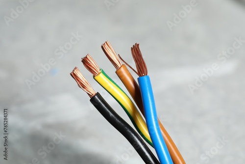 Colorful electrical wires on blurred background, closeup