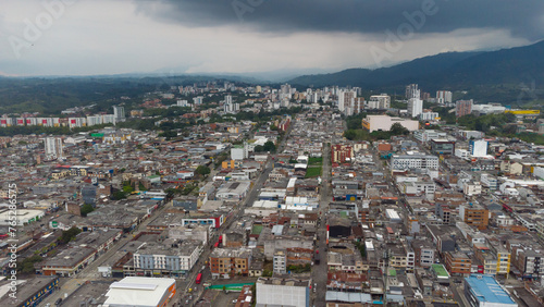 Aerial view of the city of Armenia, Quindío, Colombia. Buildings in the city of Armenia between trees and the green mountains in the background
