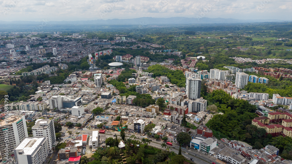 Aerial view of the city of Armenia, Quindío, Colombia. Buildings in the city of Armenia between trees and the green mountains in the background