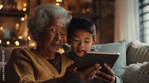 A Heartwarming Multigenerational Family Scene with Grandmother Embracing Technology and Learning, Guided by the Tech-Savvy little Grandson
