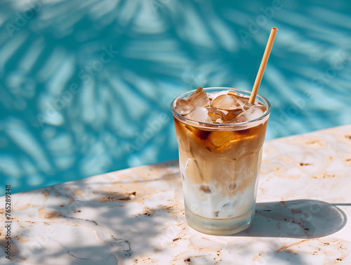 真夏のプールサイドでアイスコーヒーを飲む