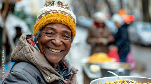 Joyous elderly black woman serving food, community help, warmth in smile, homeless charity.
