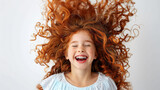 Laughing eight year old with curly blonde hair and braces on a white background, the concept of happiness in childhood.
