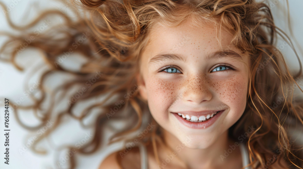 Happy girl, seven, with luscious curls and open-mouthed smile. Concept: child dental care, exuberant spirit.
Happy girl, seven, with luscious curls and open-mouthed smile. Concept: child dental care, exuberant spirit.