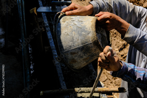 Wallpaper Mural Construction workers pour concrete on cement wall new house Torontodigital.ca