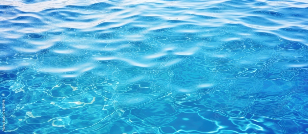 A detailed view of the calm and serene blue water surface with small, softly moving waves A detailed view of the calm and serene blue water surface with small, softly moving waves