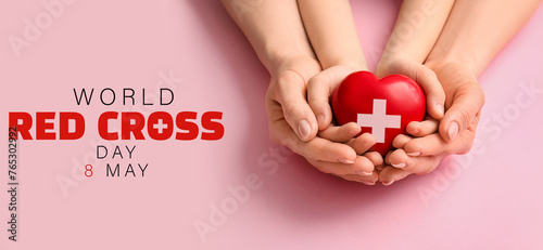 Hands of woman and child with red heart on color background, closeup photo