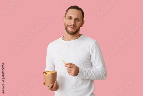 Young man with french fries...
