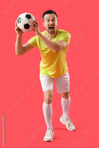 Fototapeta Naklejka Na Ścianę i Meble -  Portrait of male football player on red background
